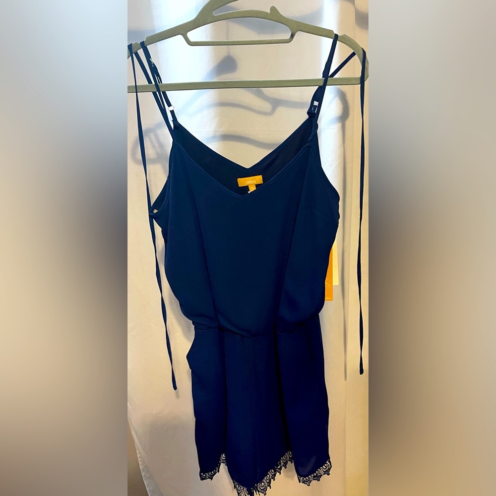 NWT BLUE ROMPER WITH LACE ON THE THIGH. SIZE MEDIUM